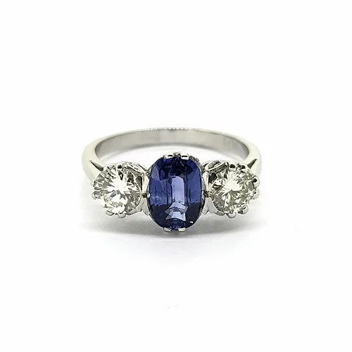 Sapphire and Diamond Three Stone Ring; central 1.40 carat oval-cut sapphire flanked by 0.95cts brilliant-cut diamonds, in platinum
