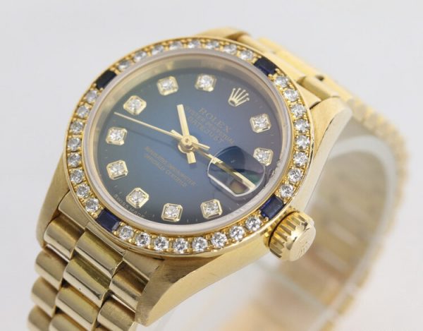 Rolex Oyster Perpetual Lady-Datejust 69088 in 18ct Yellow Gold with Original Diamond Dial and Bezel, Blue Vignette Serti dial, automatic movement, 18ct President bracelet with Crownclasp, with Rolex box and papers