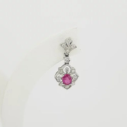 Edwardian Style Ruby and Diamond Cluster Drop Earrings; oval faceted rubies within diamond set openwork cluster surround, suspended from a diamond set fleur-de-lis stud. Mounted in 18ct white gold.