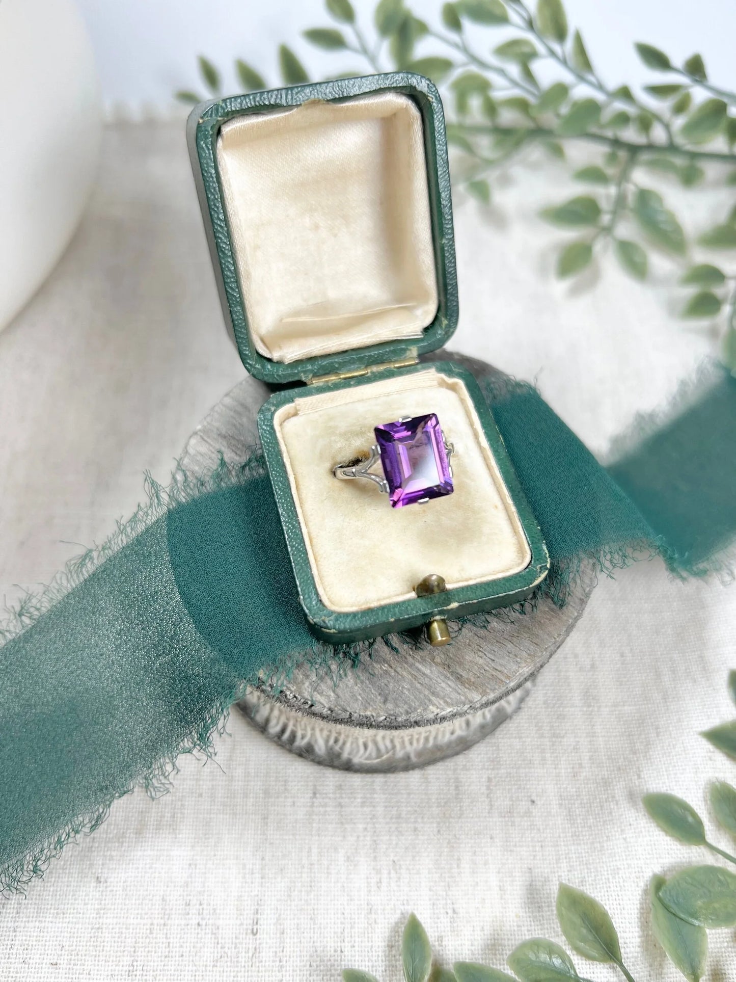 A solitaire amethyst cocktail ring in platinum, in a box