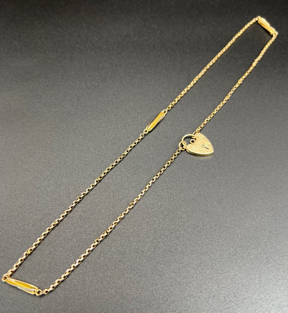 A yellow gold fancy link chain with a heart padlock