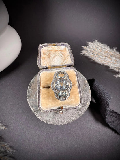 An aquamarine and diamond cocktail cluster ring, in an antique ring box