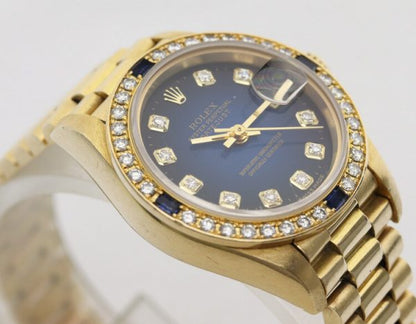 Rolex Oyster Perpetual Lady-Datejust 69088 in 18ct Yellow Gold with Original Diamond Dial and Bezel, Blue Vignette Serti dial, automatic movement, 18ct President bracelet with Crownclasp, with Rolex box and papers