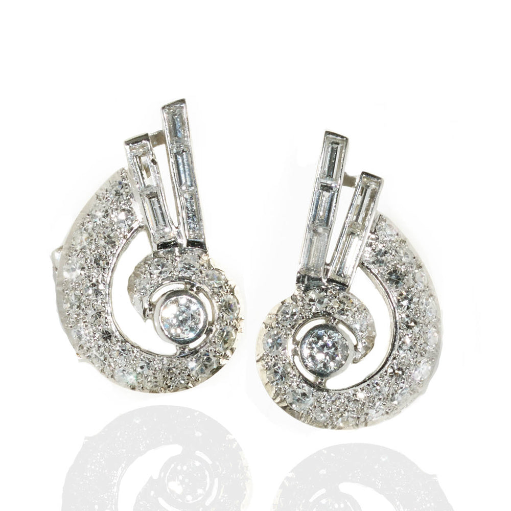 Vintage diamond set scroll clip earrings in platinum, circa 1930. 