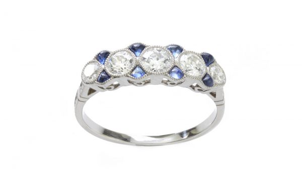 Art Deco Old Cut Diamond, Sapphire and Platinum Five Stone Ring; set with five graduated old-cut diamonds interspersed with 0.24cts cabochon sapphires, diamonds totalling 0.79 carats, Circa 1920s
