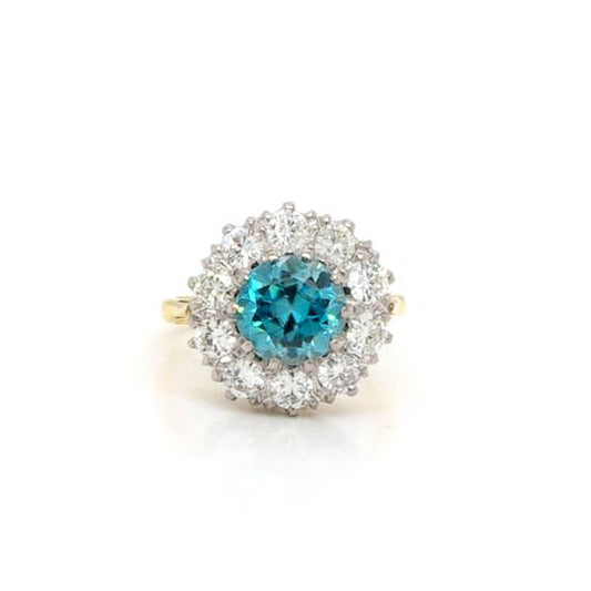 Early 20th Century Blue Zircon and Diamond Cluster Ring; a round 3.30ct blue zircon surrounded by 1.50cts old-cut diamonds, platinum and 18ct yellow gold.