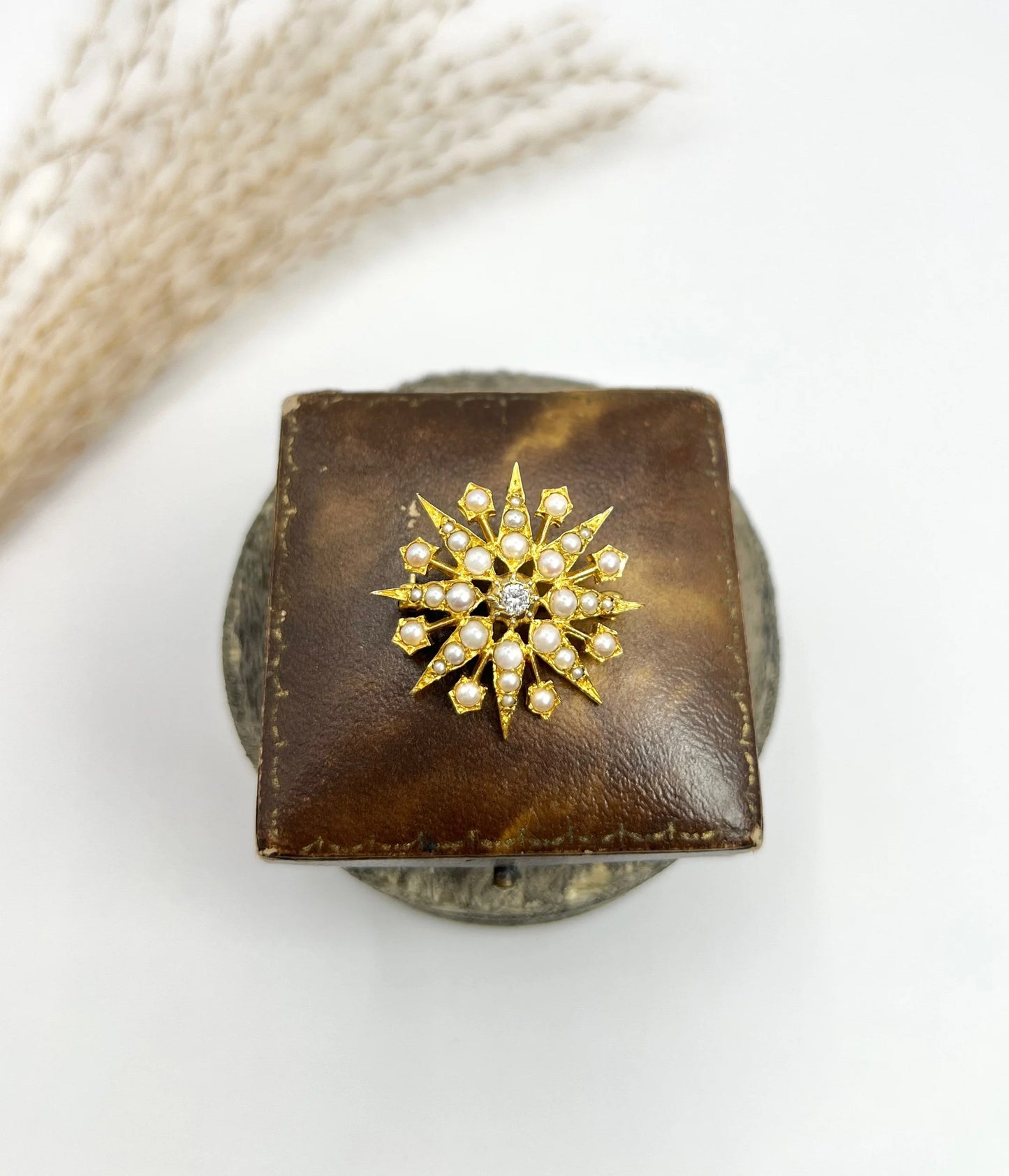 A star-shaped pearl and diamond brooch/pendant in yellow gold