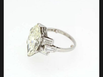 Vintage Marquise Diamond Ring; central 5.10 carat Marquise cut diamond flanked by tapered baguette diamond shoulders, in Platinum, Circa 1950