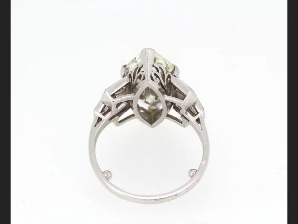 Vintage Marquise Diamond Ring; central 5.10 carat Marquise cut diamond flanked by tapered baguette diamond shoulders, in Platinum, Circa 1950