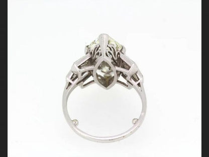 Vintage Marquise Diamond Ring; central 5.10 carat Marquise cut diamond flanked by tapered baguette diamond shoulders, in Platinum, Circa 1950