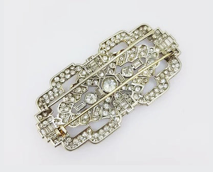 Antique Diamond and Platinum Brooch; A beautiful brooch crafted from platinum, the open-work design set with baguette-cut and circular-cut diamonds.