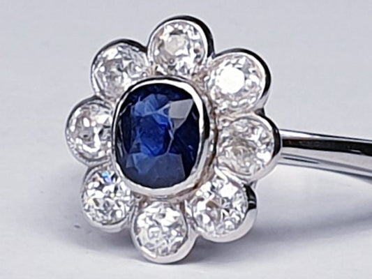 Vintage Sapphire and Old Cut Diamond Flower Cluster Ring; central 0.75 carat natural royal blue sapphire surrounded by 1.40cts old cut diamonds, on a new platinum shank