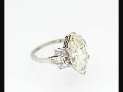 Vintage Marquise Diamond Ring; central 5.10 carat Marquise cut diamond flanked by tapered baguette diamond shoulders, in Platinum, Circa 1950