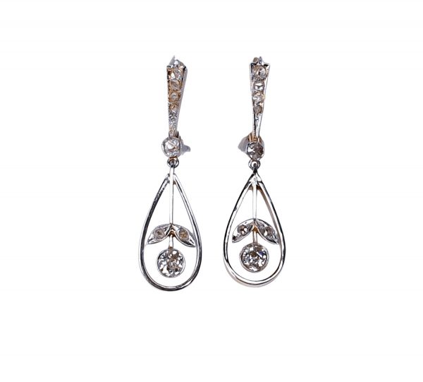 Antique Edwardian Diamond Drop Earrings; 0.60 carat total, with graduating top suspending an articulated pear drop with flower inset, in platinum and backed with 18ct yellow gold