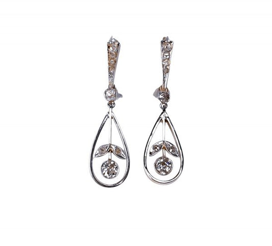 Antique Edwardian Diamond Drop Earrings; 0.60 carat total, with graduating top suspending an articulated pear drop with flower inset, in platinum and backed with 18ct yellow gold