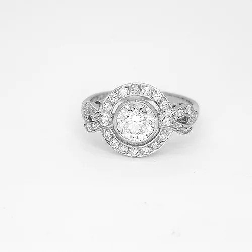 Diamond and Platinum Cluster Dress Ring; central 0.75 carat round brilliant-cut diamond surrounded by diamond halo border and diamond set shoulders, 1.10 carat total