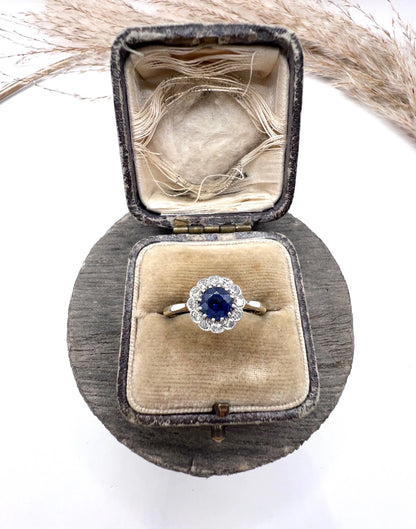 A sapphire and diamond flower cluster ring in yellow gold and platinum, in a ring box