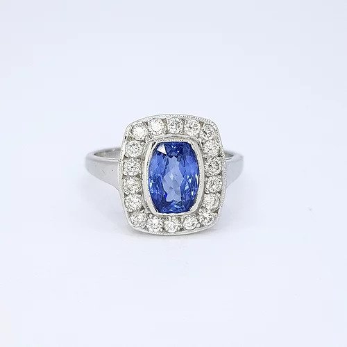 1.80ct Sapphire and Diamond Rectangular Cluster Ring; eye-catching rectangular shaped cluster ring, 1.80ct oval cut sapphire surrounded by 0.75cts diamonds, in 18ct white gold