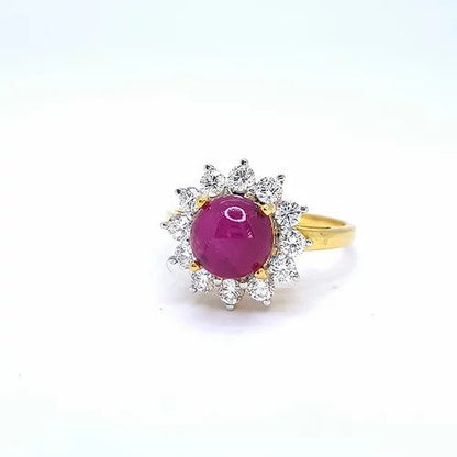 Cabochon Burma Ruby and Diamond Cluster Ring; central round cabochon Burmese ruby surrounded by sparkling diamonds, in 18ct yellow gold