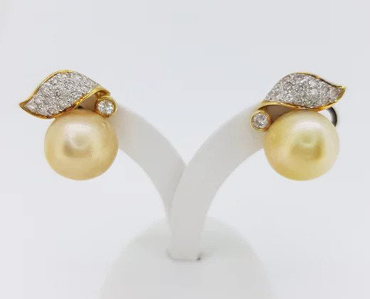Vintage Golden South Sea Pearl and Diamond Earrings, striking golden South Sea pearls, accented with diamond set leaves, in 18ct yellow gold
