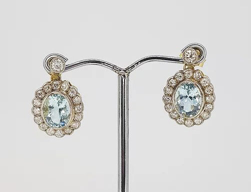 Aquamarine and Diamond Oval Cluster Drop Earrings; 3.80cts oval aquamarines surrounded by 1.35cts diamonds, suspended from a diamond set stud
