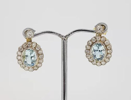 Aquamarine and Diamond Oval Cluster Drop Earrings; 3.80cts oval aquamarines surrounded by 1.35cts diamonds, suspended from a diamond set stud