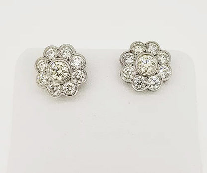 Diamond Daisy Flower Cluster Stud Earrings, mounted in 18ct white gold, in a rub-over setting with fine millegrain borders.