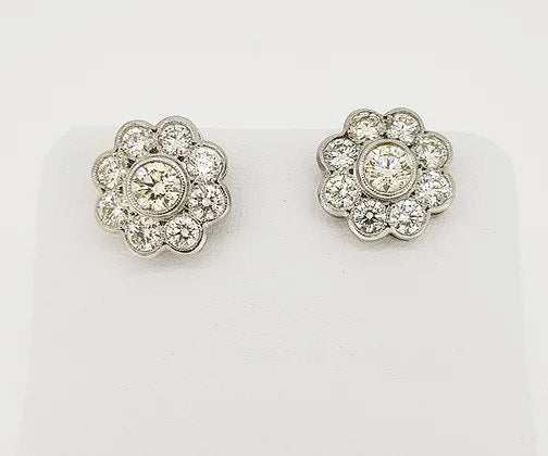 Diamond Daisy Flower Cluster Stud Earrings, mounted in 18ct white gold, in a rub-over setting with fine millegrain borders.