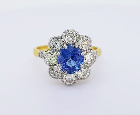 Vintage 1.70ct Natural Sapphire and Diamond Oval Cluster Ring; featuring a natural oval sapphire surrounded by 1.35cts brilliant cut diamonds, in 18ct gold.