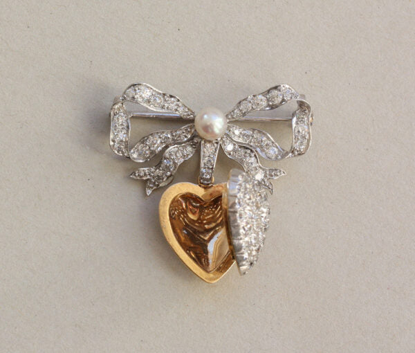 Antique Edwardian Diamond and Pearl Bow and Heart Locket Brooch; set with 1.08cts old-cut diamonds and a natural pearl, platinum and 18ct gold
