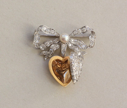 Antique Edwardian Diamond and Pearl Bow and Heart Locket Brooch; set with 1.08cts old-cut diamonds and a natural pearl, platinum and 18ct gold