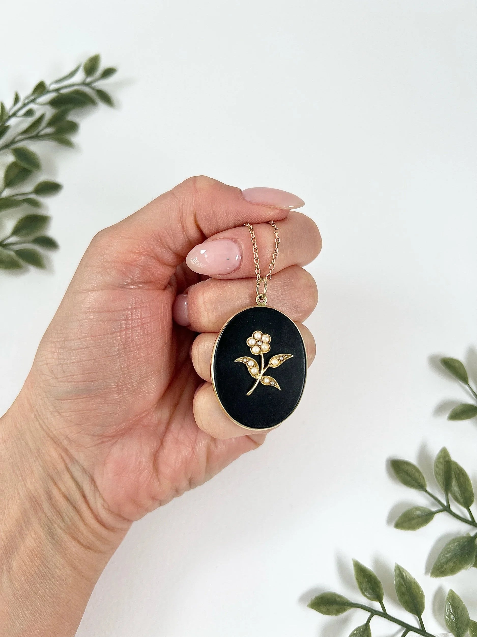 Edwardian 18 Carat Yellow Gold Onyx and Seed Pearl Flower Locket, Circa 1900