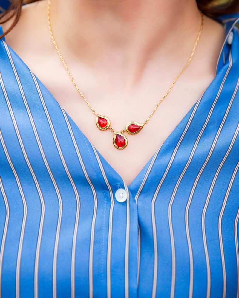 Gold pendant necklace with three fire opals.
