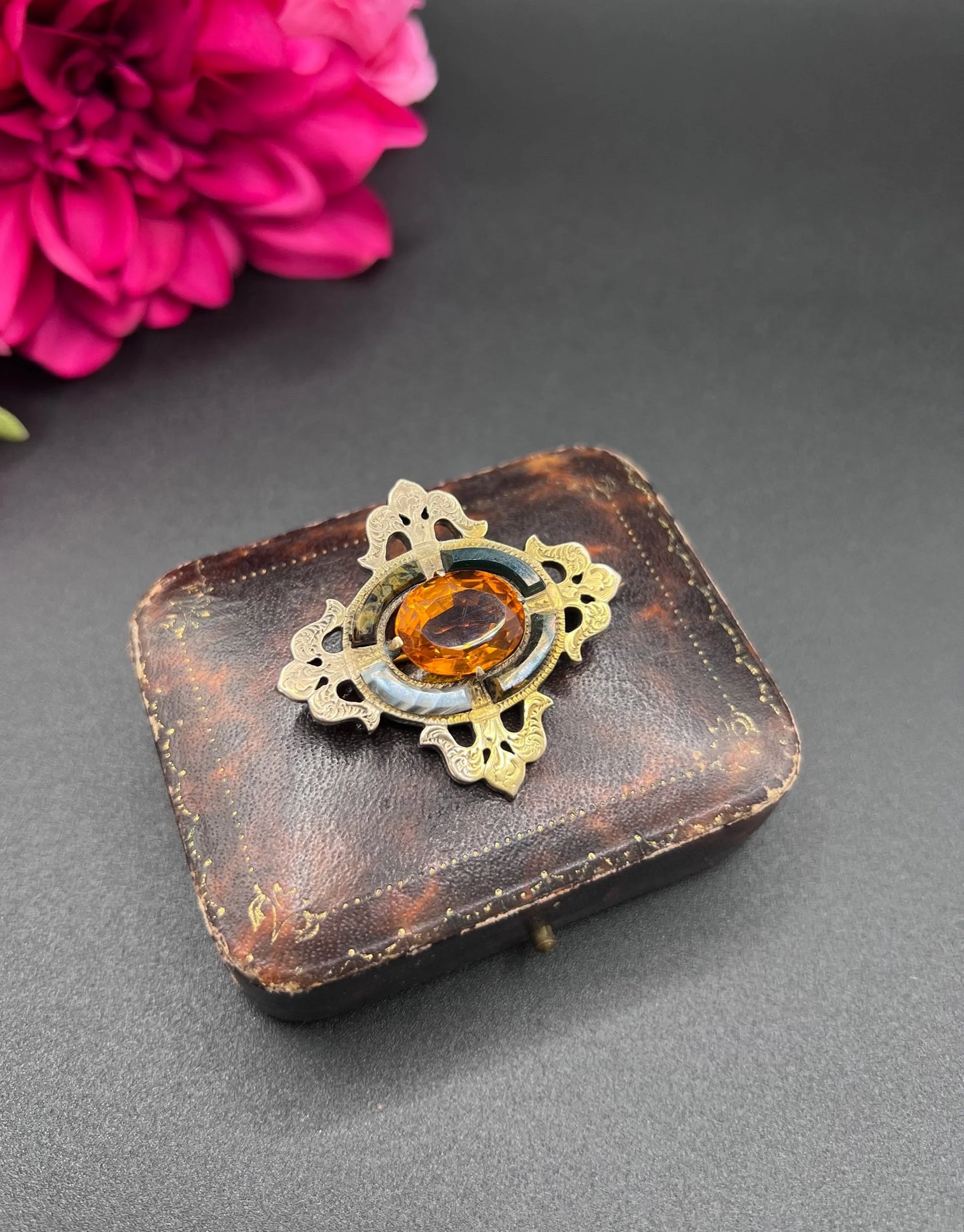 A yellow gold, oval citrine and agate ornate brooch