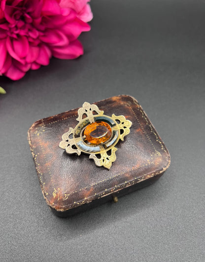 A yellow gold, oval citrine and agate ornate brooch