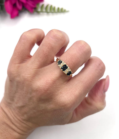 A seven stone sapphire and diamond carved ring in yellow gold, modelled on a hand