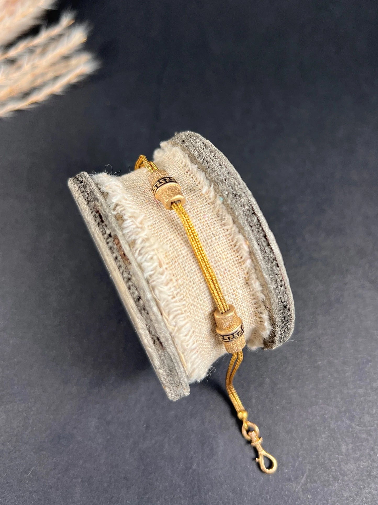 A yellow gold double row bracelet with black enamel tubular beads