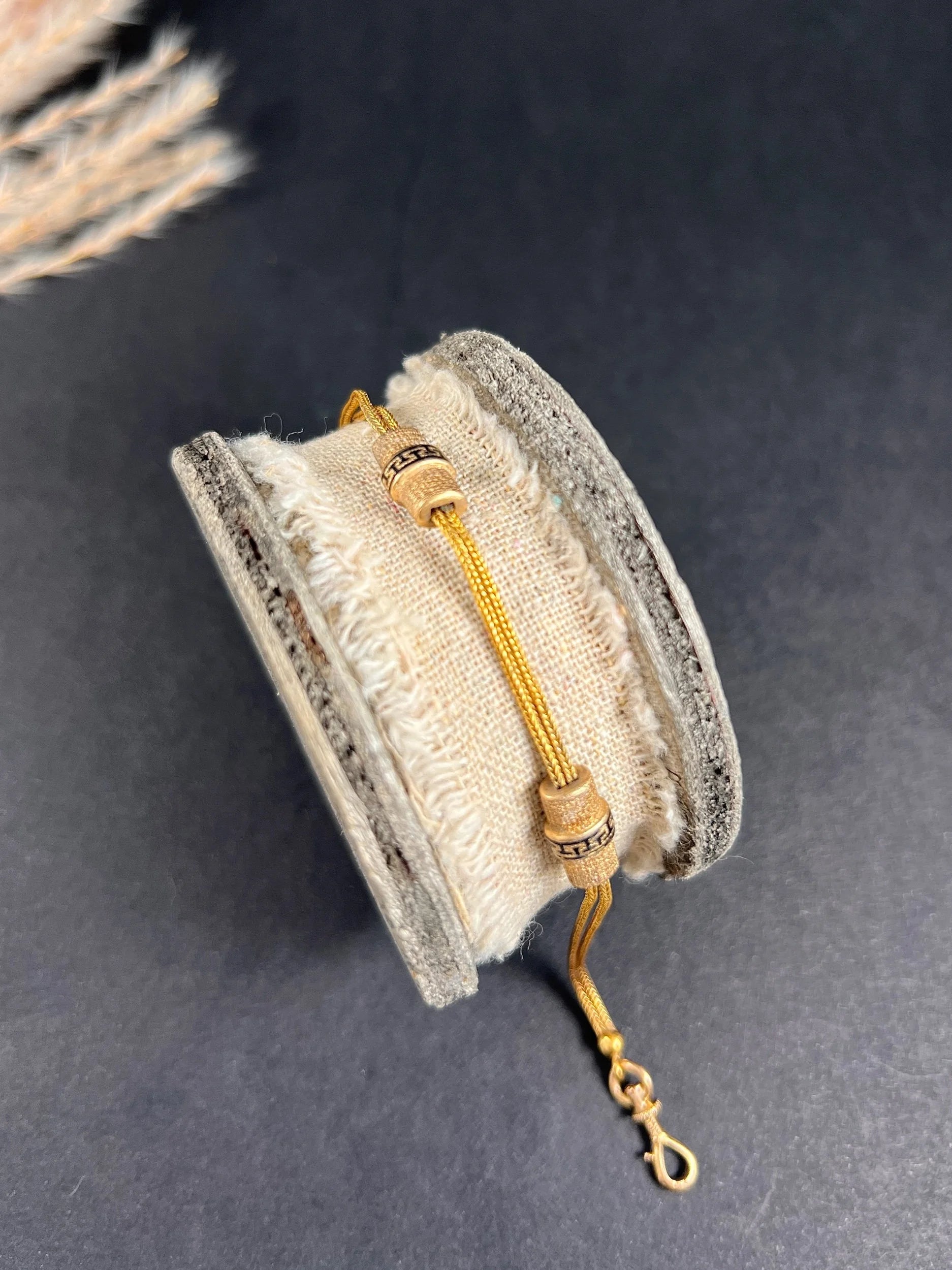 A yellow gold double row bracelet with black enamel tubular beads