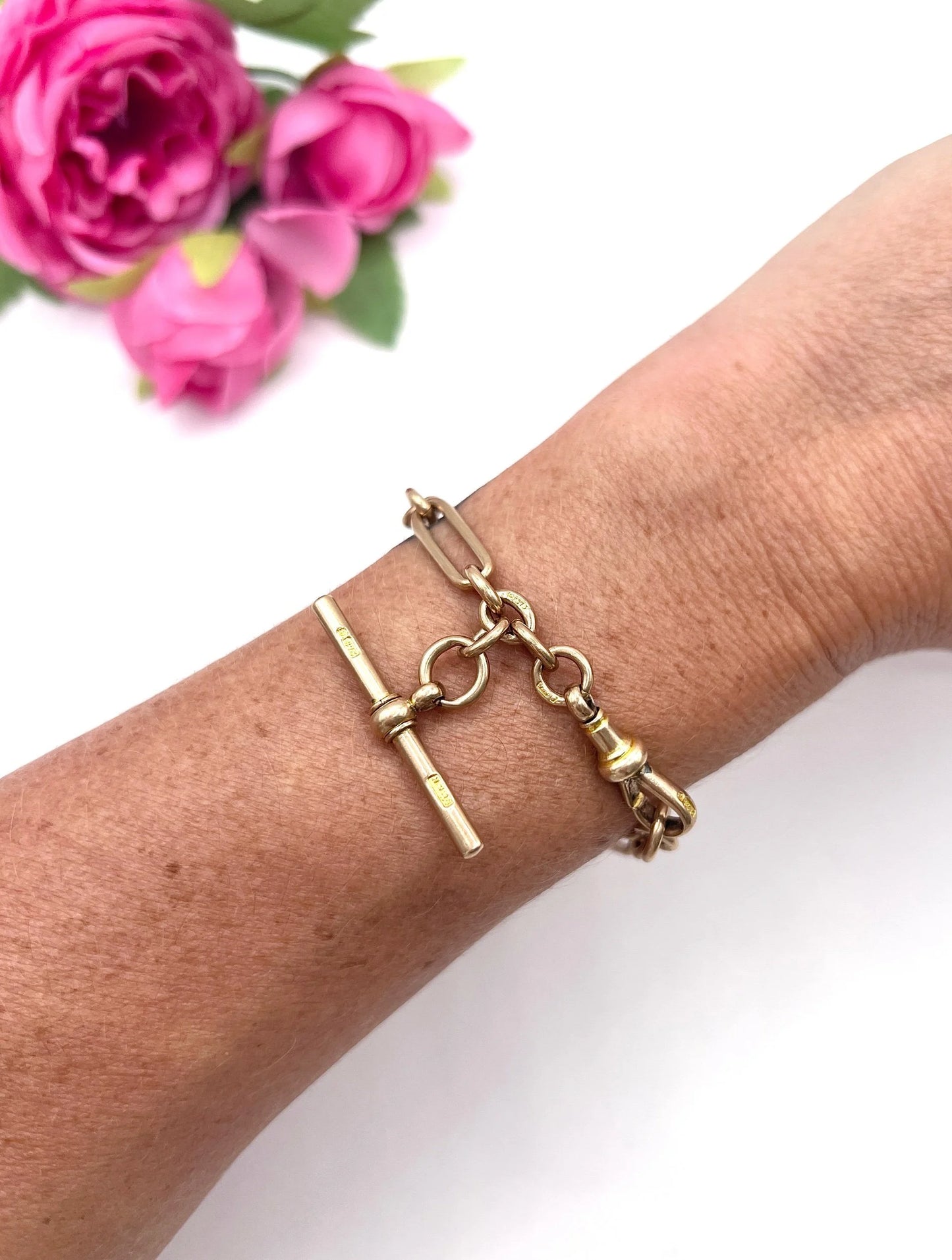 A rose gold link bracelet with a T-bar, modelled on a wrist