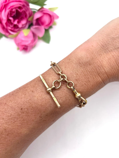 A rose gold link bracelet with a T-bar, modelled on a wrist