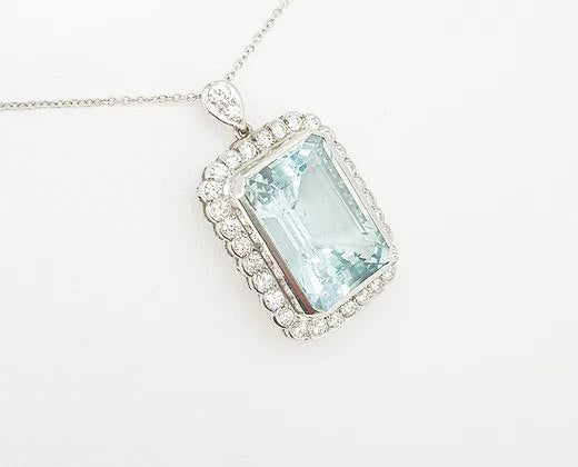 Aquamarine and Diamond Cluster Pendant; 15.00 carat emerald-cut aquamarine with 1.25ct brilliant-cut diamond border, diamond set bale, with chain