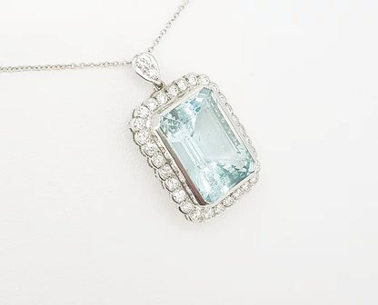 Aquamarine and Diamond Cluster Pendant; 15.00 carat emerald-cut aquamarine with 1.25ct brilliant-cut diamond border, diamond set bale, with chain