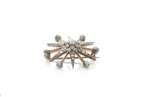 Antique Victorian Old Cut Diamond Star Brooch; set with rose cut and old European cut diamonds, 0.88 carat total, set in silver and 15ct gold