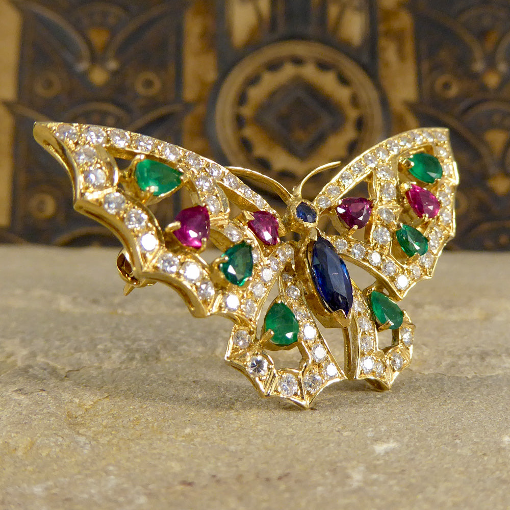 Contemporary diamond emerald ruby and sapphire butterfly brooch in 18ct gold
