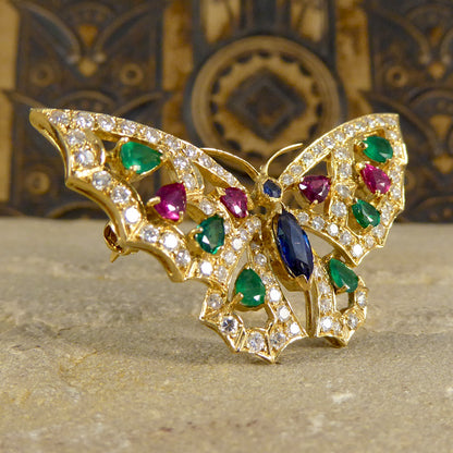 Contemporary diamond emerald ruby and sapphire butterfly brooch in 18ct gold