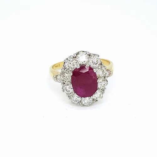 Ruby and Diamond Oval Cluster Ring; featuring a 2.30 carat oval faceted ruby within a cluster of ten round brilliant-cut diamonds with diamond set shoulders, 1.35cts, in 18ct yellow gold