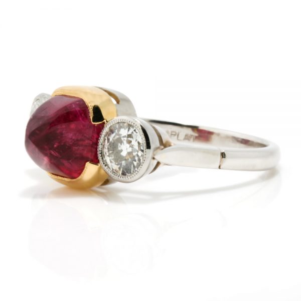 Art Deco Natural Cabochon Ruby and Diamond Trilogy Ring; central 4.52ct cabochon-cut natural ruby flanked by 1cts old-cut diamonds, in 18ct yellow gold and platinum, Circa 1920, with GCS certificate