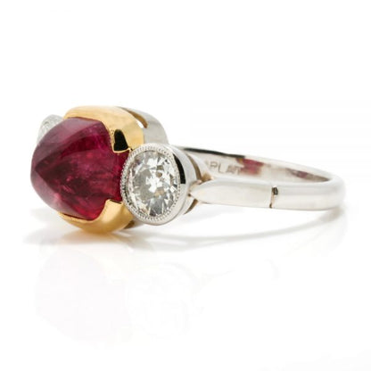 Art Deco Natural Cabochon Ruby and Diamond Trilogy Ring; central 4.52ct cabochon-cut natural ruby flanked by 1cts old-cut diamonds, in 18ct yellow gold and platinum, Circa 1920, with GCS certificate
