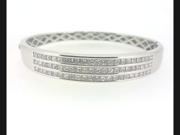 Princess Cut Diamond Bangle; Triple row of  princess cut diamonds channel set into solid 18ct white gold hinged bangle. Diamond total weight: 4.80 carats