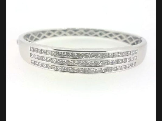 Princess Cut Diamond Bangle; Triple row of  princess cut diamonds channel set into solid 18ct white gold hinged bangle. Diamond total weight: 4.80 carats